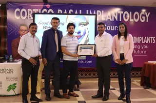 Dr. Kumar Gaurav receiving cortico basal implantology award at DENTIN Multispeciality Dental Clinic & Implant Center, HSR Layout Bengaluru